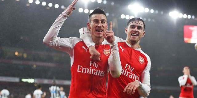 LONDON, ENGLAND - JANUARY 02: Laurent Koscielny (L) of Arsenal celebrates scoring his team's first goal with his team mate Aaron Ramsey (R) during the Barclays Premier League match between Arsenal and Newcastle United at Emirates Stadium on January 2, 2016 in London, England. (Photo by Shaun Botterill/Getty Images)