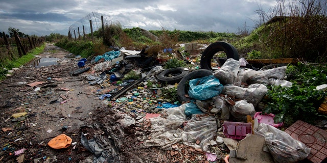 FILE -- In this Nov. 18, 2013 photo, rubbish is piled up on the edge of cultivated land near Caivano, in the surroundings of Naples, southern Italy.