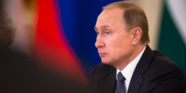 Russian President Vladimir Putin attends a meeting with Russian and Indian officials and businessmen during his meeting with Indian Prime Minister Narendra Modi in the Kremlin in Moscow, Thursday, Dec. 24, 2015. (AP Photo/Pavel Golovkin)