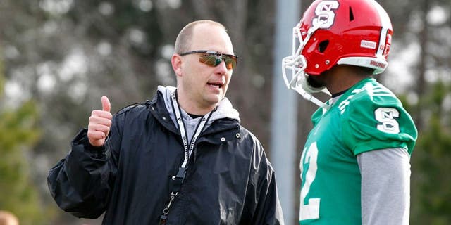 N.C. State Wolfpack offensive coordinator Matt Canada talks with Jacoby Brissett (12) during spring football practice in Raleigh, N.C., on Wednesday, March 5, 2014. (Ethan Hyman/Raleigh News & Observer/MCT)