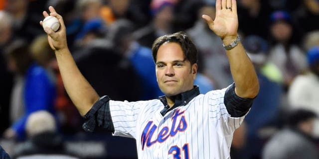 Oct 30, 2015; New York City, NY, USA; New York Mets former catcher Mike Piazza waves to the crowd before throwing the ceremonial first pitch before game three of the World Series against the Kansas City Royals at Citi Field. Mandatory Credit: Robert Deutsch-USA TODAY Sports