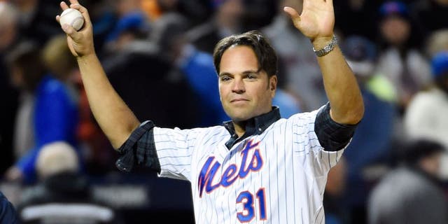 Oct 30, 2015; New York City, NY, USA; New York Mets former catcher Mike Piazza waves to the crowd before throwing the ceremonial first pitch before game three of the World Series against the Kansas City Royals at Citi Field. Mandatory Credit: Robert Deutsch-USA TODAY Sports