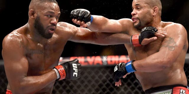 LAS VEGAS, NV - JANUARY 03: Jon Jones (L) and Daniel Cormier (R) exchange punches in their UFC light heavyweight championship bout during the UFC 182 event at the MGM Grand Garden Arena on January 3, 2015 in Las Vegas, Nevada. (Photo by Jeff Bottari/Zuffa LLC/Zuffa LLC via Getty Images)