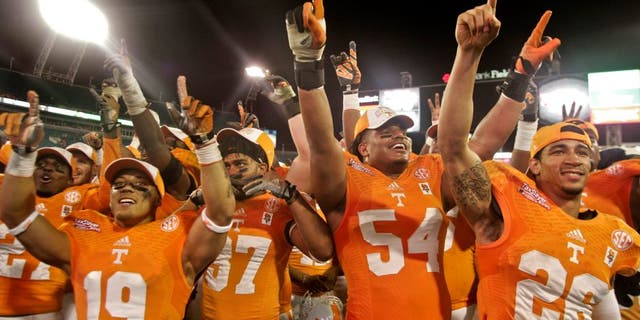 Jan 2, 2015; Jacksonville, FL, USA; Tennessee Volunteers running back Devrin Young (19) and defensive back Brian Randolph (37) and defensive tackle Jordan Williams (54) and defensive back Geraldo Orta (26) celebrate with fans after their 2015 TaxSlayer Bowl game against the Iowa Hawkeyes at EverBank Field. The Tennessee Volunteers beat the Iowa Hawkeyes 45-28. Mandatory Credit: Phil Sears-USA TODAY Sports