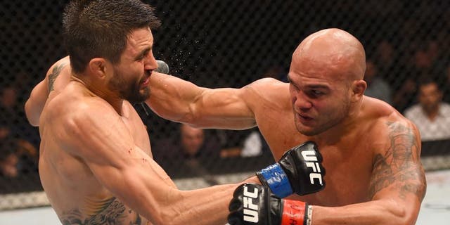 LAS VEGAS, NV - JANUARY 02: (R-L) Robbie Lawler punches Carlos Condit in their UFC welterweight championship bout during the UFC 195 event inside MGM Grand Garden Arena on January 2, 2016 in Las Vegas, Nevada. (Photo by Josh Hedges/Zuffa LLC/Zuffa LLC via Getty Images)