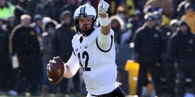 Nov 21, 2015; Iowa City, IA, USA; Purdue Boilermakers quarterback Austin Appleby (12) points downfield against the Iowa Hawkeyes during the fourth quarter at Kinnick Stadium. Iowa beat Purdue 40-20. Mandatory Credit: Reese Strickland-USA TODAY Sports