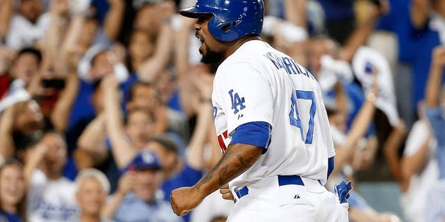 LOS ANGELES, CA - OCTOBER 10: Howie Kendrick #47 of the Los Angeles Dodgers celebrates after he slides home safely to score on a two-RBI double by Adrian Gonzalez #23 of the Los Angeles Dodgers in the seventh inning against the New York Mets in game two of the National League Division Series at Dodger Stadium on October 10, 2015 in Los Angeles, California. (Photo by Sean M. Haffey/Getty Images)