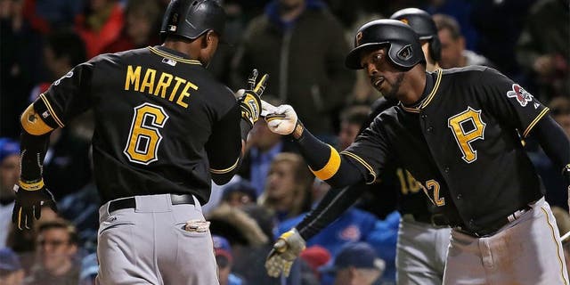 CHICAGO, IL - APRIL 28: Starling Marte #6 of the Pittsburgh Pirates is greeted by Andrew McCutchen #22 after hitting a two run home run in the 4th inning against the Chicago Cubs at Wrigley Field on April 28, 2015 in Chicago, Illinois. (Photo by Jonathan Daniel/Getty Images)