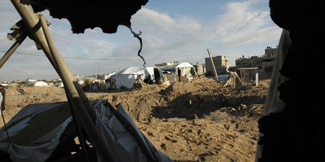 Jan. 5: Palestinians survey the damage after an Israeli air strike on a smuggling tunnel in the southern Gaza Strip, along the Gaza-Egypt border.