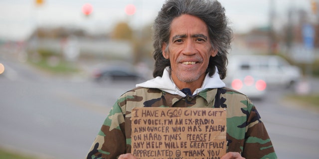 In this photo taken in late December, 2010, Ted Williams holds a sign advertising his smooth radio voice near a highway ramp in Columbus, Ohio.