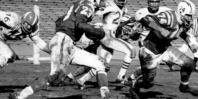 Half back Paul Lowe and offensive tackle Ron Mix of the Los Angeles Chargers run upfield in a 21 to 24 win over the Houston Oilers on November 13, 1960 at Los Angeles Memorial Colesium in Los Angeles, California. (Photo by Vic Stein/Getty Images) *** Local Caption ***