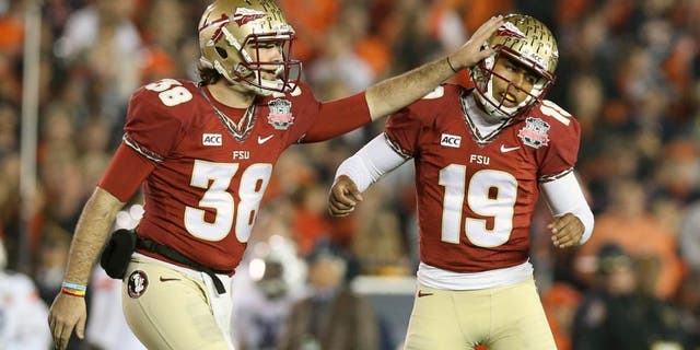 Jan 6, 2014; Pasadena, CA, USA; Florida State Seminoles kicker Roberto Aguayo (19) is congratulated by punter Cason Beatty (38) after he kicked a 41 yard field goal against the Auburn Tigers during the second half of the 2014 BCS National Championship game at the Rose Bowl. Mandatory Credit: Matthew Emmons-USA TODAY Sports