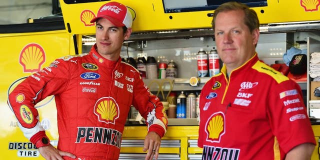 CHARLOTTE, NC - MAY 23: Joey Logano, driver of the #22 Shell Pennzoil Ford, stands in the garage area with his crew chief Todd Gordon during practice for the NASCAR Sprint Cup Series Coca-Cola 600 at Charlotte Motor Speedway on May 23, 2015 in Charlotte, North Carolina. (Photo by Jared C. Tilton/Getty Images)