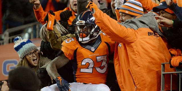 Jan 3, 2016; Denver, CO, USA; Denver Broncos running back Ronnie Hillman (23) celebrates scoring a touchdown in the fourth quarter against the San Diego Chargers at Sports Authority Field at Mile High. The Broncos defeated the Chargers 27-20. Mandatory Credit: Ron Chenoy-USA TODAY Sports