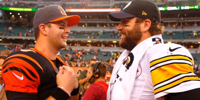 Dec 13, 2015; Cincinnati, OH, USA; Pittsburgh Steelers quarterback Ben Roethlisberger (R) talks with Cincinnati Bengals quarterback AJ McCarron (L) after the Steelers beat the Bengals 33-20 at Paul Brown Stadium. Mandatory Credit: David Kohl-USA TODAY Sports