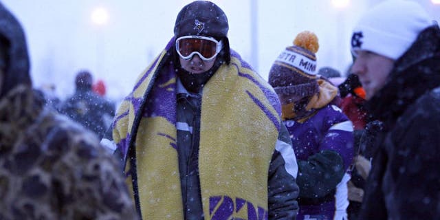 Snow continues to fall, as fans arrive at TCF Bank Stadium for the Minnesota Vikings' game against the Chicago Bears in Minneapolis, Minnesota, Monday, December 20, 2010. (Brian Cassella/Chicago Tribune/MCT via Getty Images)