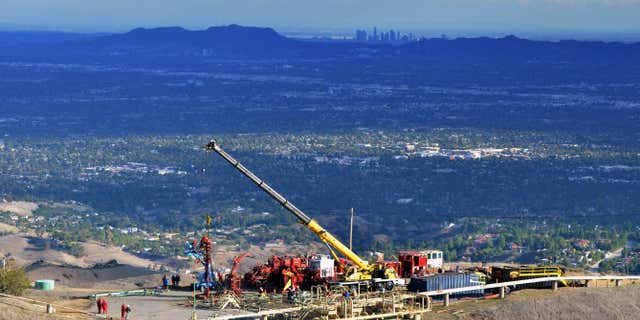 FILE - In this Nov. 3, 2015, file photo, provided by Southern California Gas Co., SoCalGas crews and technical experts attempt to safely stop the flow of natural gas leaking from a storage well at the utility’s Aliso Canyon facility near the Northridge section of Los Angeles.