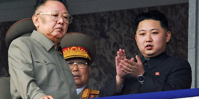 In this Oct. 10, 2010 file photo North Korea leader Kim Jong Il, left, walks by his son Kim Jong Un on the balcony as they attend a massive military parade marking the 65th anniversary of the communist nation's ruling Workers' Party in Pyongyang, North Korea.