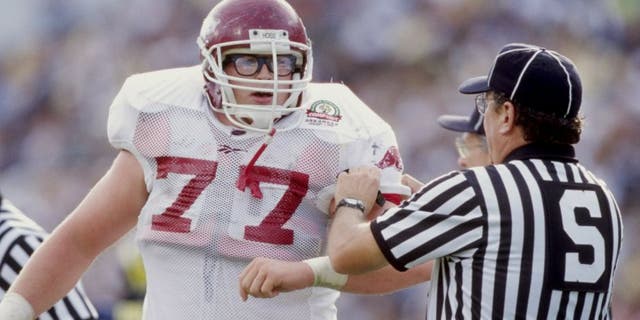 1 Jan 1999: Brandon Burlsworth #77 of the Arkansas Razorbacks is helped by an official during the Citrus Bowl against the Michigan Wolverines at the Florida Citrus Bowl in Orlando, Florida. Michigan defeated Arkansas 45-31. Mandatory Credit: Andy Lyons /Allsport