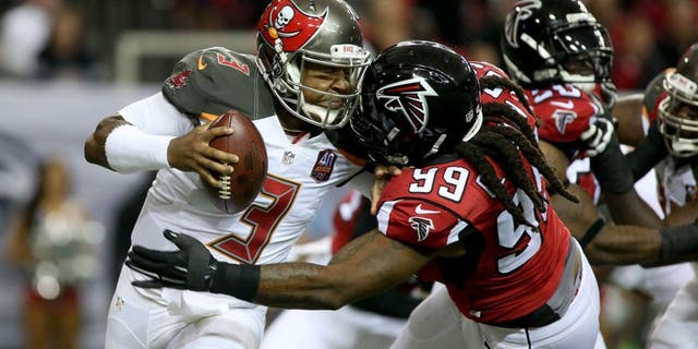 Nov 1, 2015; Atlanta, GA, USA; Tampa Bay Buccaneers quarterback Jameis Winston (3) is hit by Atlanta Falcons defensive end Adrian Clayborn (99) but prevents the tackle from Clayborn in the first quarter of their game at the Georgia Dome. Mandatory Credit: Jason Getz-USA TODAY Sports