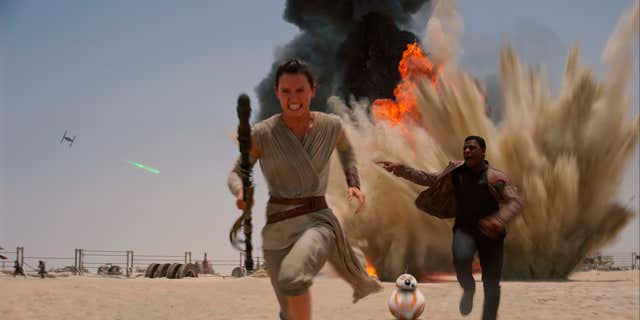 FILE- This undated file photo provided by Disney shows Daisey Ridley as Rey, left, and John Boyega as Finn, in a scene from the film, "Star Wars: The Force Awakens."