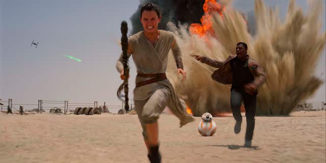 FILE- This undated file photo provided by Disney shows Daisey Ridley as Rey, left, and John Boyega as Finn, in a scene from the film, "Star Wars: The Force Awakens."