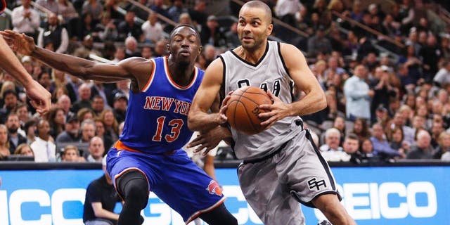 Jan 8, 2016; San Antonio, TX, USA; San Antonio Spurs point guard Tony Parker (right) drives to the basket around New York Knicks point guard Jerian Grant (13) during the first half at AT&T Center. Mandatory Credit: Soobum Im-USA TODAY Sports