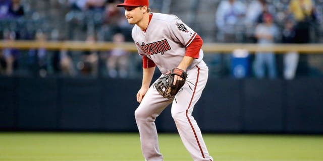 DENVER, CO - AUGUST 31: Second baseman Phil Gosselin #15 of the Arizona Diamondbacks plays defense against the Colorado Rockies at Coors Field on August 31, 2015 in Denver, Colorado. The Rockies defeated the Diamondbacks 5-4. (Photo by Doug Pensinger/Getty Images)
