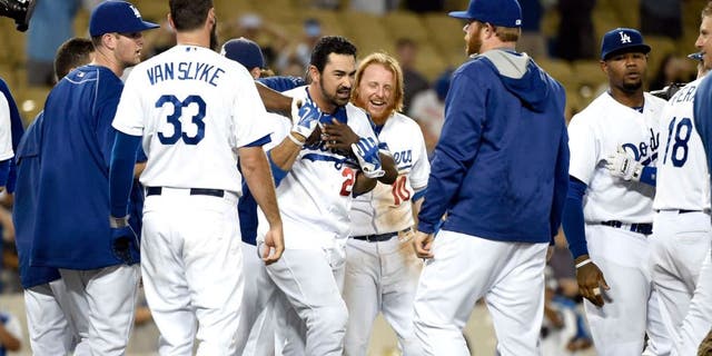 Aug 31, 2015; Los Angeles, CA, USA; Los Angeles Dodgers first baseman Adrian Gonzalez (23) celebrates with teammates after hitting a walk off during the fourteenth inning against the San Francisco Giants at Dodger Stadium. Mandatory Credit: Richard Mackson-USA TODAY Sports