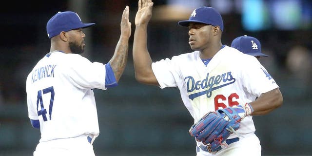 LOS ANGELES, CA - JULY 29: Yasiel Puig #66 and Howie Kendrick #47 of the Los Angeles Dodgers celebrate after the game against the Oakland Athletics at Dodger Stadium on July 29, 2015 in Los Angeles, California. The Dodgers won 10-7. (Photo by Stephen Dunn/Getty Images)
