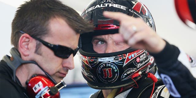 LAS VEGAS, NV - MARCH 07: Kevin Harvick (right), driver of the #4 Jimmy John's Chevrolet, speaks with his crew chief Rodney Childers during practice for the NASCAR Sprint Cup Series Kobalt 400 at Las Vegas Motor Speedway on March 7, 2014 in Las Vegas, Nevada. (Photo by Nick Laham/Getty Images)