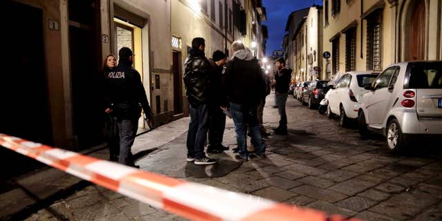 Jan. 9, 2016: Italian police officers stand outside an apartment where 35-year-old American woman Ashley Oslen was found dead, in Florence, Italy