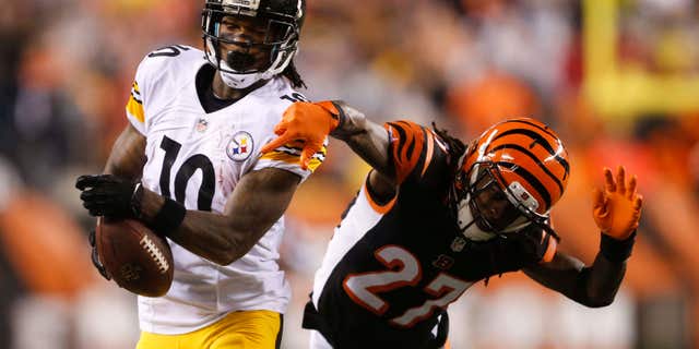 Pittsburgh Steelers wide receiver Martavis Bryant (10) is tackled by Cincinnati Bengals' Dre Kirkpatrick (27) during the second half of an NFL wild-card playoff football game Saturday, Jan. 9, 2016, in Cincinnati.