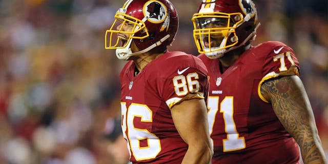 LANDOVER, MD - JANUARY 10: Tight end Jordan Reed #86 of the Washington Redskins celebrates with teammate tackle Trent Williams #71 after scoring a second quarter touchdown against the Green Bay Packers during the NFC Wild Card Playoff game at FedExField on January 10, 2016 in Landover, Maryland. (Photo by Elsa/Getty Images)