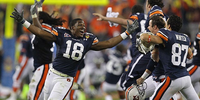 Jan. 10: Auburn's Kodi Burns (18) and teammates celebrate after beating Oregon 22-19 in the BCS National Championship game in Glendale, Ariz.