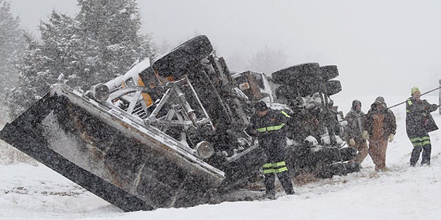 Jan 10: A Douglas County, Kansas, snowplow flips over on an interstate amid an unusually cold storm (AP).