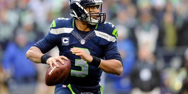 Dec 22, 2013; Seattle, WA, USA; Seattle Seahawks quarterback Russell Wilson (3) looks looks for an open receiver during the first half against the Arizona Cardinals at CenturyLink Field. Mandatory Credit: Steven Bisig-USA TODAY Sports