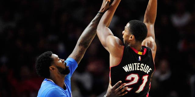 January 11, 2015; Los Angeles, CA, USA; Miami Heat center Hassan Whiteside (21) shoots against the defense of Los Angeles Clippers center DeAndre Jordan (6) during the second half at Staples Center. Mandatory Credit: Gary A. Vasquez-USA TODAY Sports