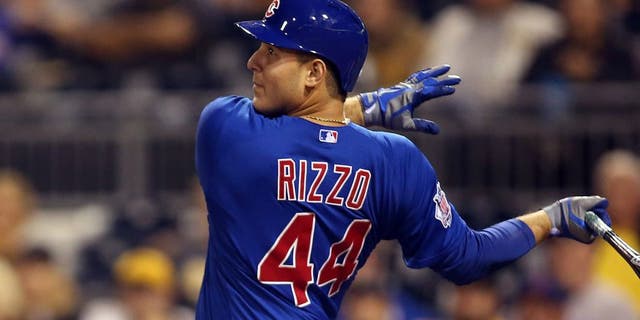 Sep 16, 2015; Pittsburgh, PA, USA; Chicago Cubs first baseman Anthony Rizzo (44) hits a sacrifice fly RBI against the Pittsburgh Pirates during the twelfth inning at PNC Park. The Cubs won 3-2 in twelve innings. Mandatory Credit: Charles LeClaire-USA TODAY Sports