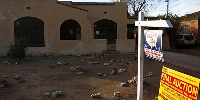 Jan. 4: A realtor and bank-owned sign is displayed near a house for sale in Phoenix, Arizona.