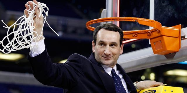 Apr 5, 2010; Indianapolis, IN, USA; Duke Blue Devils head coach Mike Krzyzewski waves to the crowd after cutting down a piece of the net after defeating the Butler Bulldogs 61-59 in the national championship game of the Final Four of the 2010 NCAA mens basketball tournament at Lucas Oil Stadium. Mandatory Credit: Bob Donnan-USA TODAY Sports