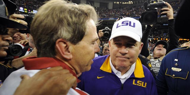 Jan 9, 2012; New Orleans, LA, USA; LSU Tigers head coach Les Miles (right) shakes hands with Alabama Crimson Tide head coach Nick Saban after the 2012 BCS National Championship game at the Mercedes-Benz Superdome. Mandatory Credit: John David Mercer-USA TODAY Sports