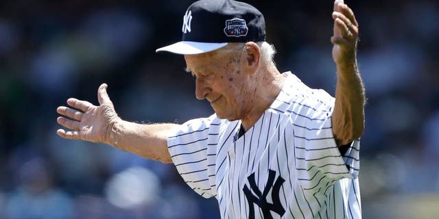 FILE- In this June 23, 2013, file photo, former New York Yankees relief pitcher and scout Luis Arroyo acknowledges the crowd as he is introduced to fans before the Yankees 67th annual Old Timers Day baseball game at Yankee Stadium in New York. The Yankees said Arroyo's daughter, Milagros, told the team Wednesday, Jan. 13, 2016, that Arroyo had died earlier in the day in Puerto Rico. He was 88. (AP Photo/Kathy Willens, File)