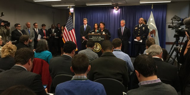 Attorney General Lynch at the podium, with Mayor Rahm Emanuel and Police Supt. Eddie Johnson, right.