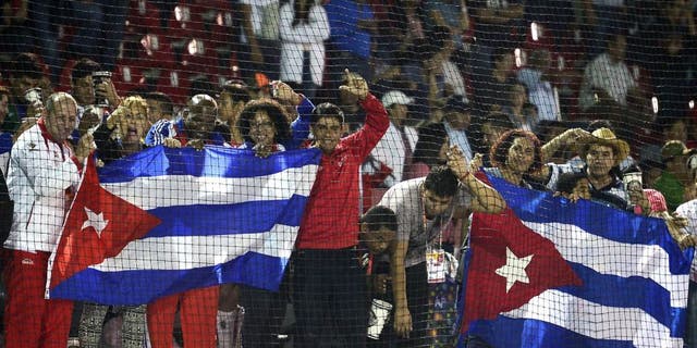 Cuban fans celebrate after winning the Gold medal against Nicaragua during the final match of Baseball, at the XXII Central American and Caribbean Games, in Veracruz, Mexico, on November 21, 2014. The Games bring together nearly 8,000 athletes from 31 countries and run through November 30. AFP PHOTO/RONALDO SCHEMIDT (Photo credit should read RONALDO SCHEMIDT/AFP/Getty Images)