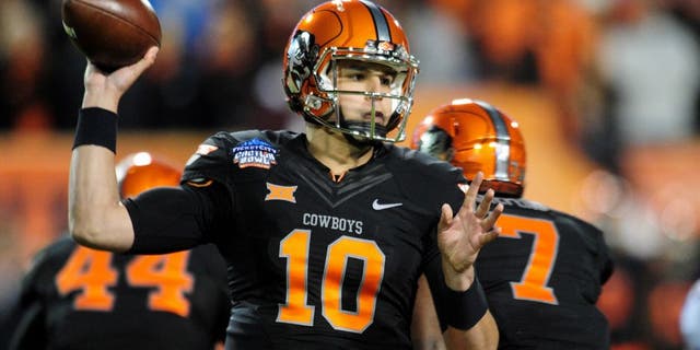 Jan 2, 2015; Tempe, AZ, USA; Oklahoma State Cowboys quarterback Mason Rudolph (10) throws during the first half against the Washington Huskies in the 2015 Cactus Bowl at Sun Devil Stadium. Mandatory Credit: Matt Kartozian-USA TODAY Sports