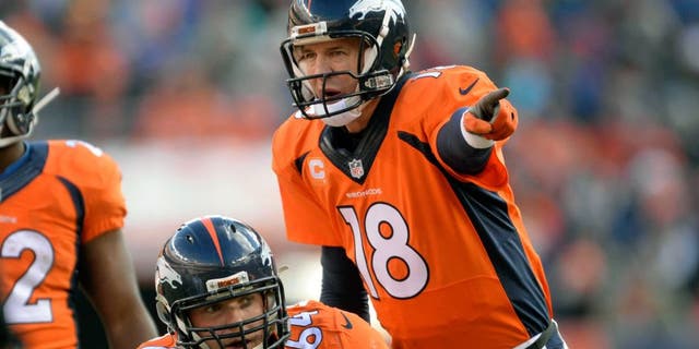 Dec 28, 2014; Denver, CO, USA; Denver Broncos quarterback Peyton Manning (18) calls an audible over center Will Montgomery (64) in the first quarter against the Oakland Raiders at Sports Authority Field at Mile High. Mandatory Credit: Ron Chenoy-USA TODAY Sports