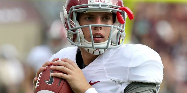 Sep 14, 2013; College Station, TX, USA; Alabama Crimson Tide quarterback Luke Del Rio (14) throws to stretch prior to the second half against the Texas A&M Aggies at Kyle Field. Mandatory Credit: Matthew Emmons-USA TODAY Sports