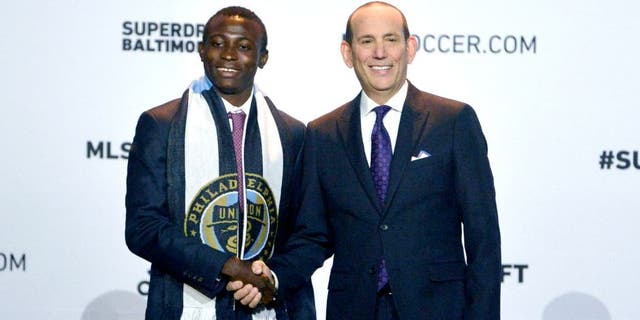 Jan 14, 2016; Baltimore, MD, USA; Joshua Yaro shakes hands with commissioner Don Garber after being selected number two overall by the Philadelphia Union during the 2016 MLS SuperDraft at Baltimore Convention Center. Mandatory Credit: Tommy Gilligan-USA TODAY Sports