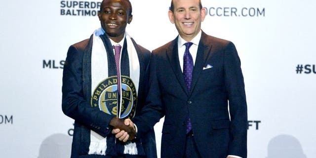Jan 14, 2016; Baltimore, MD, USA; Joshua Yaro shakes hands with commissioner Don Garber after being selected number two overall by the Philadelphia Union during the 2016 MLS SuperDraft at Baltimore Convention Center. Mandatory Credit: Tommy Gilligan-USA TODAY Sports